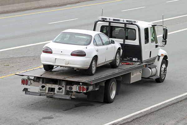 Tow truck transporting car